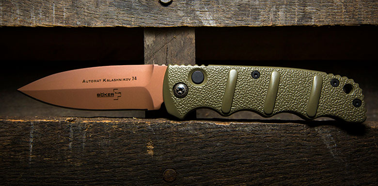 Photo of Boker Kalashnikov Automatic Knife in Desert Warrior, displayed on reclaimed wood box.