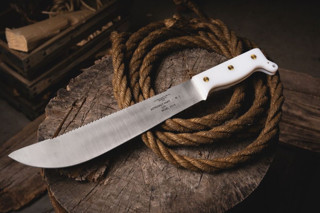 The Case Astronaut Knife M-1 on a stump with some rope.