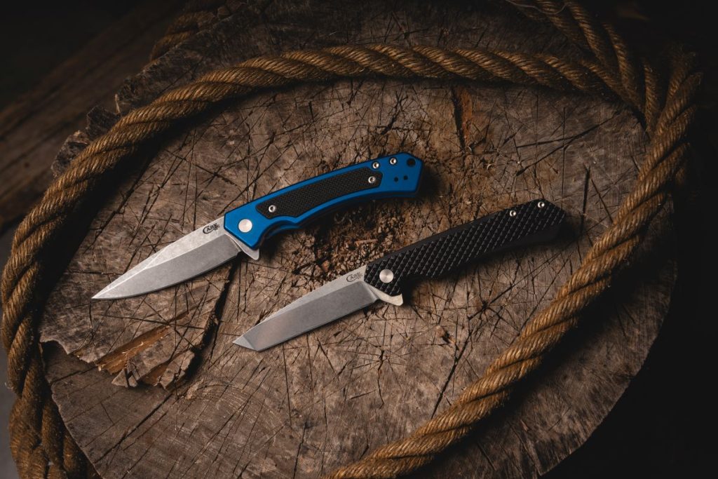 The Case Knives Marilla and Kinzua—modern folding knives—on a stump with some rope.