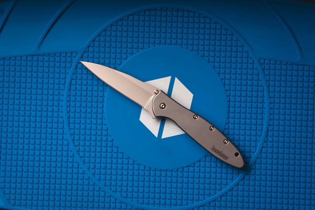 A Kershaw Leek on a blue Blade HQ shop mat.