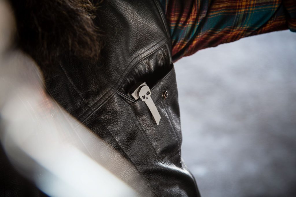 Chaves Knives skull pocket clip titanium in a leather vest pocket