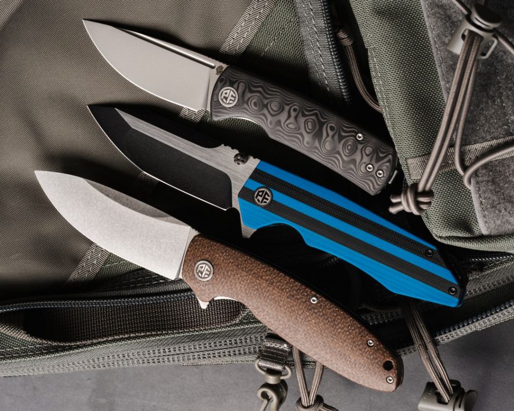 three petrified fish knives sitting on top of a backpack