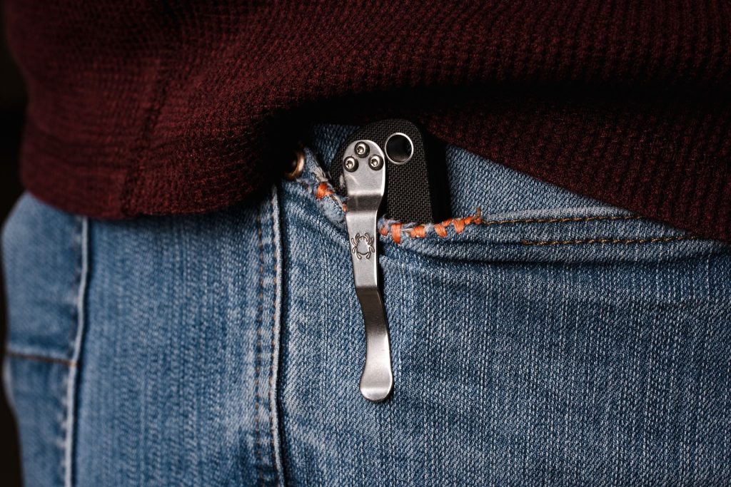 A Spyderco Paramilitary 2 pocket knife in a man's pocket, showing off the pocket clip.