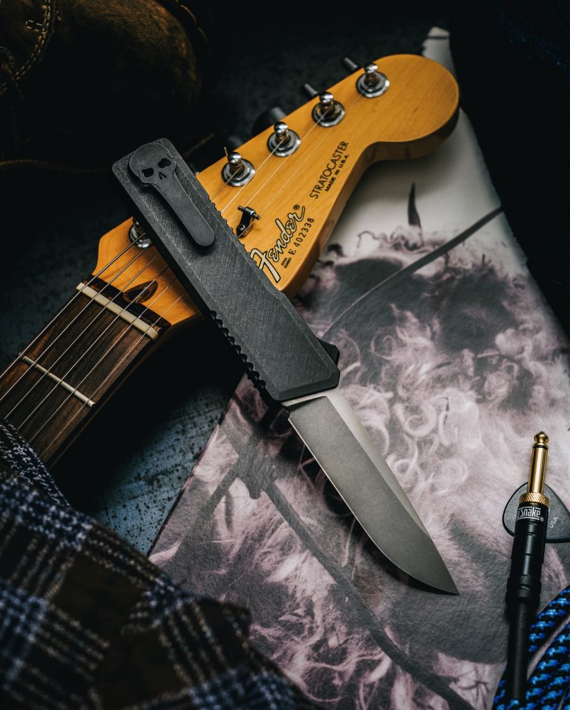 Chaves Dissident OTF beside a guitar.