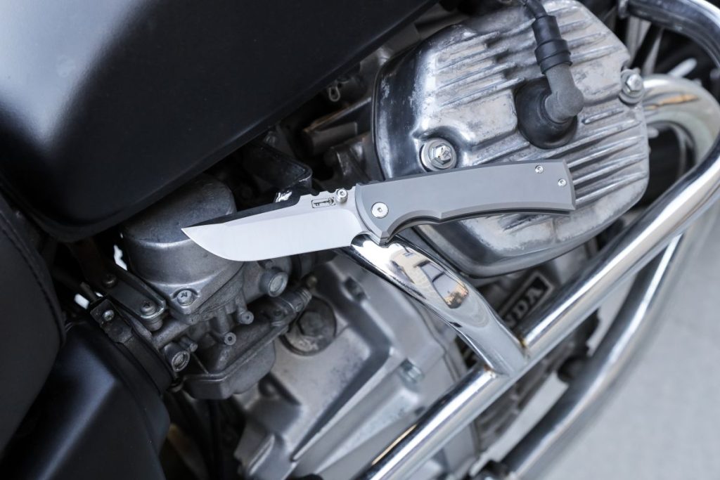 A Chaves Redencion knife on a motorcycle engine.