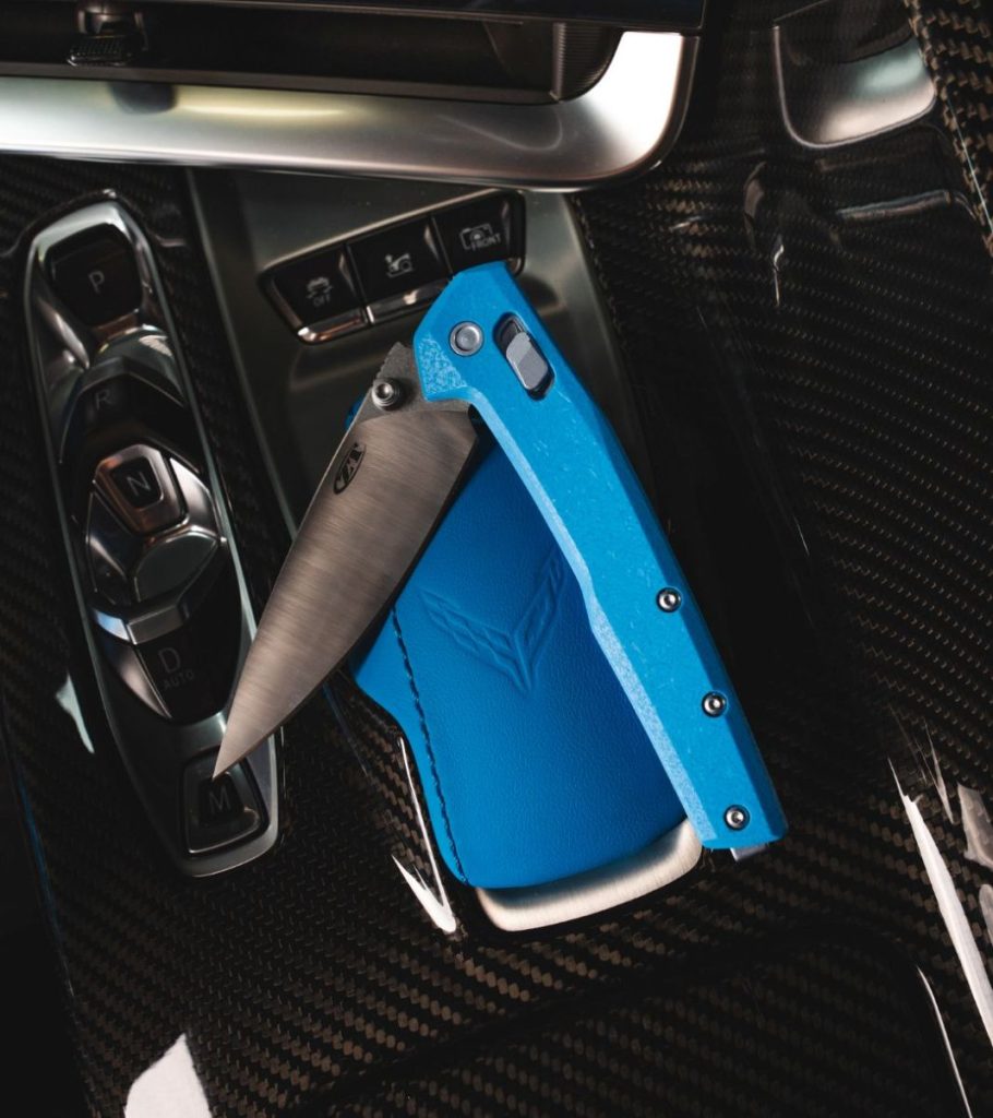 The Blade HQ exclusive ZT 0117GBLU resting in the interior of a Corvette with blue trim.